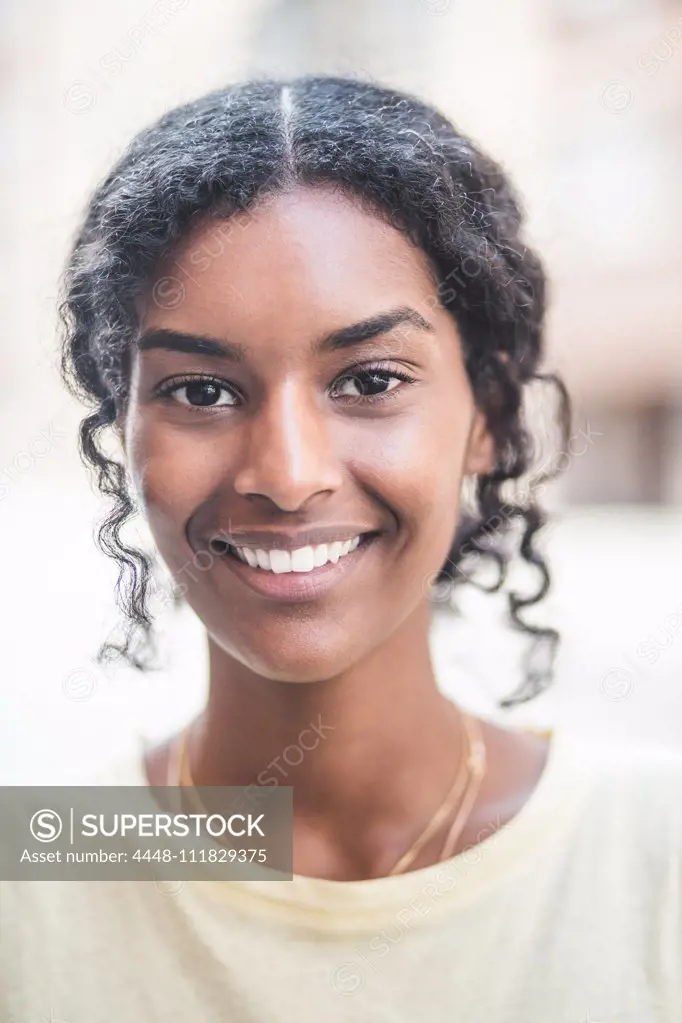 Portrait of smiling woman in city