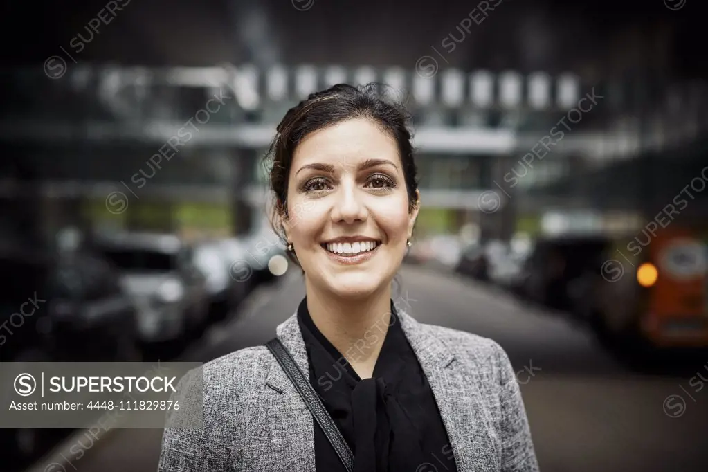 Portrait of smiling confident female lawyer in formals at workplace