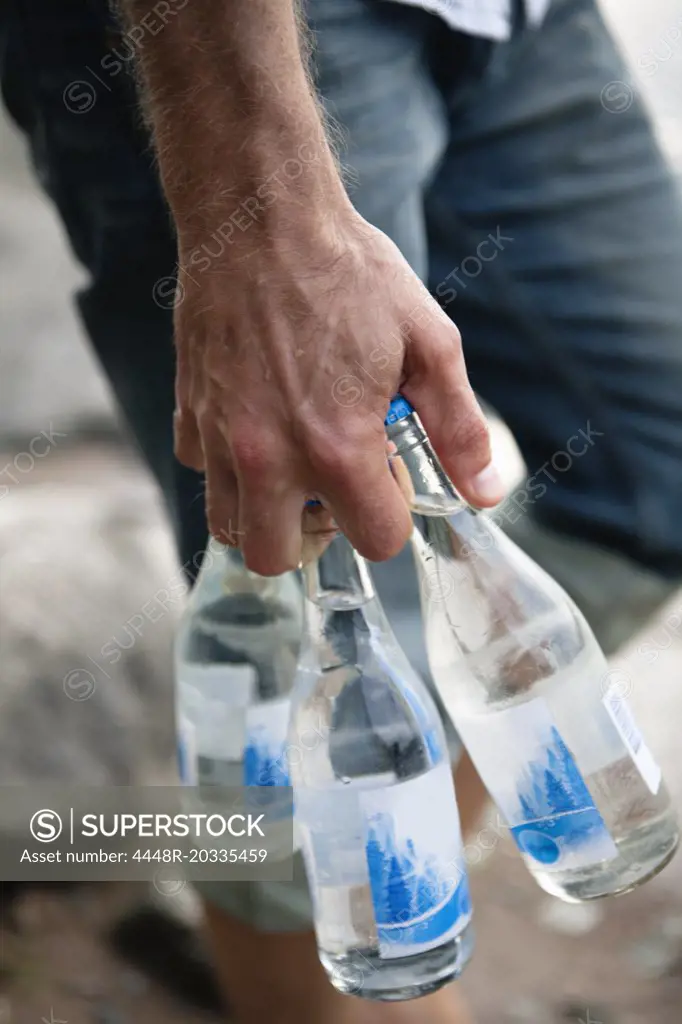 Hand holding bottles