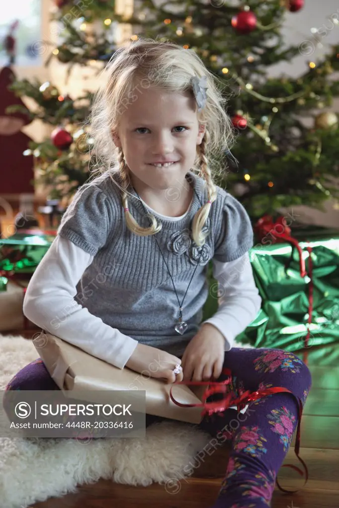 Girl opening christmas present