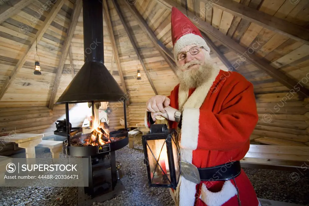 Santa Claus holding lamp in cot