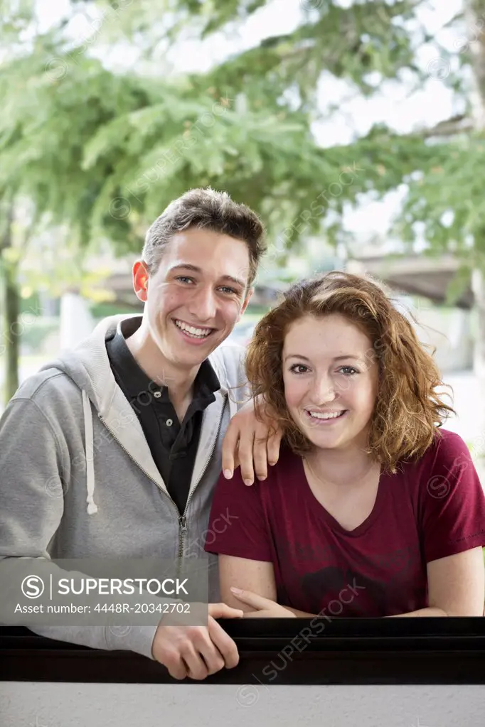 Portrait of happy young friends standing together