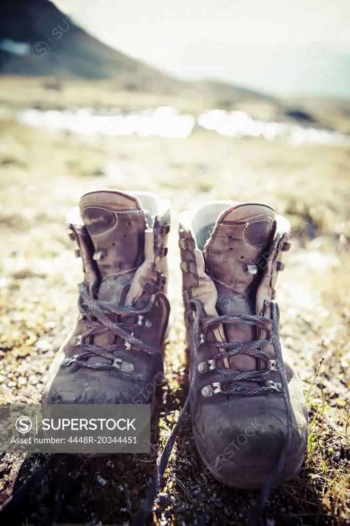 Pair of dirty hiking boots on land