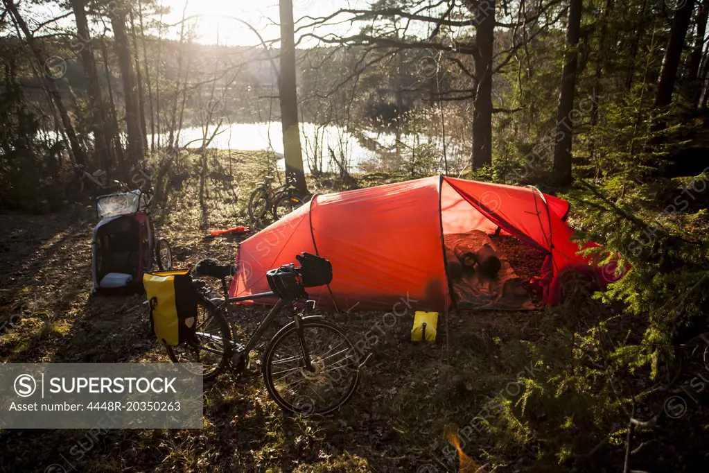 Tent and bicycle at lakeshore