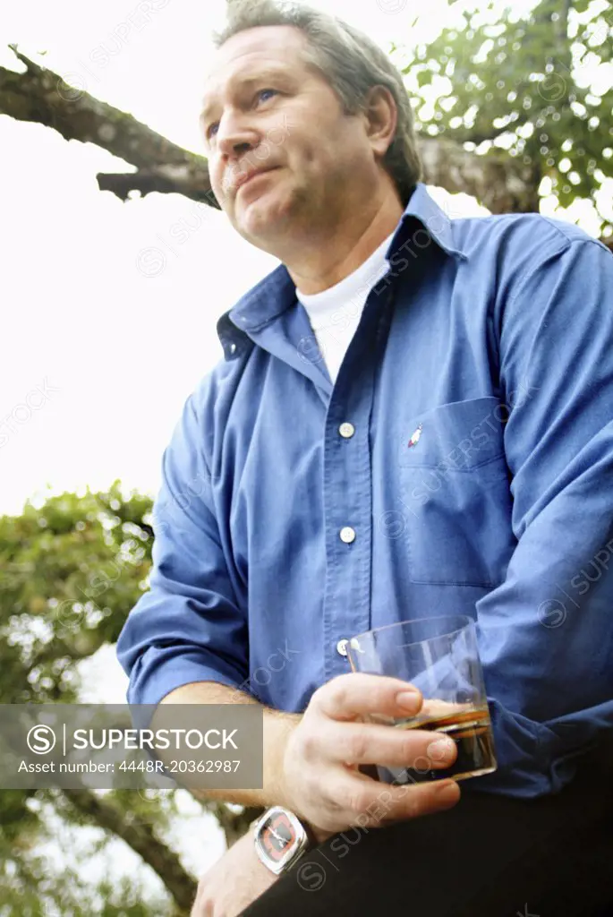 Man drinking whiskey outdoors