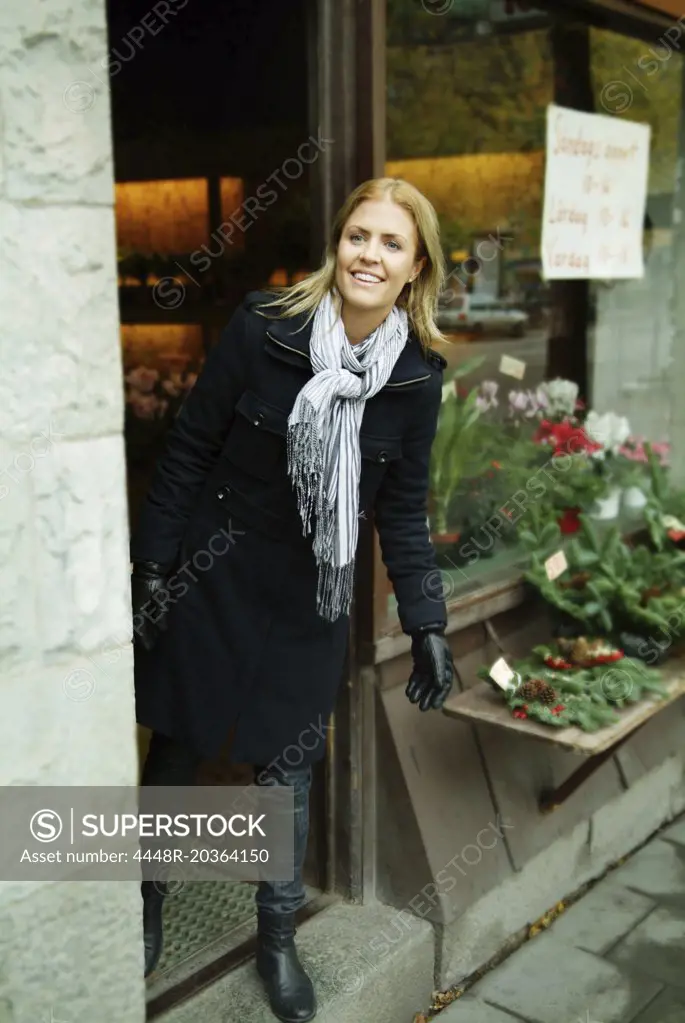 Woman looking out from a store