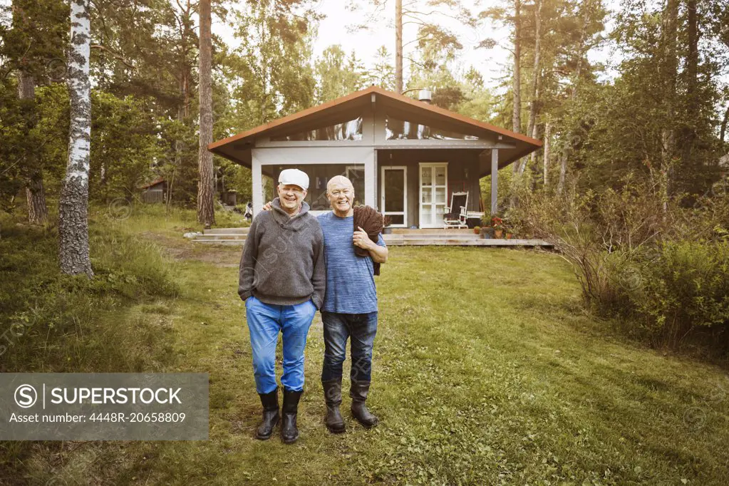 Portrait of happy gay couple standing at lawn