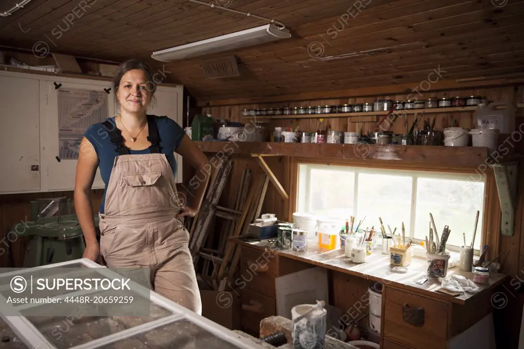 Portrait of confident upholsterer standing at workshop