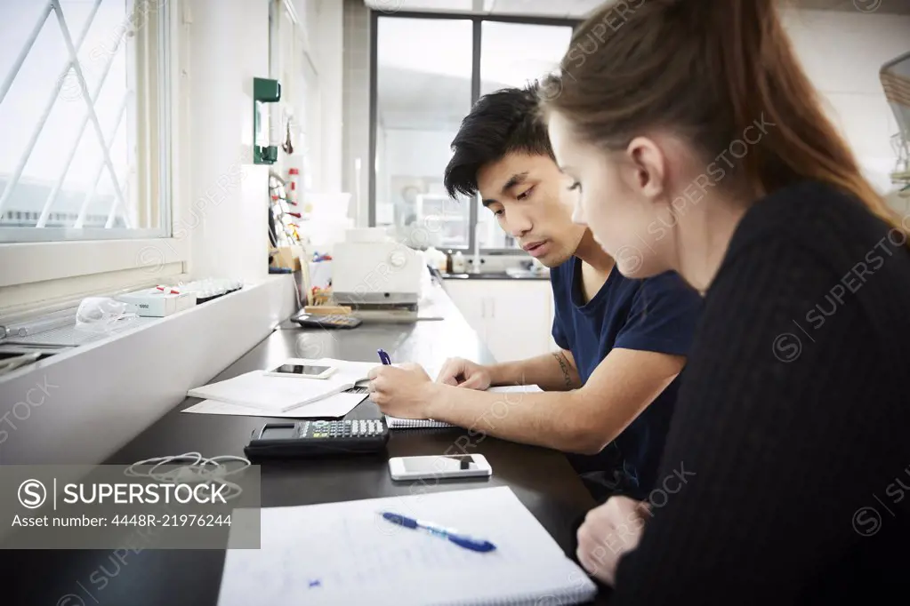 Young multi-ethnic university students studying together in classroom