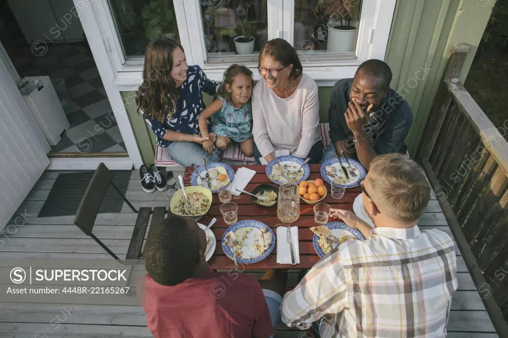 High angle view of multi-generation family having lunch at table on porch