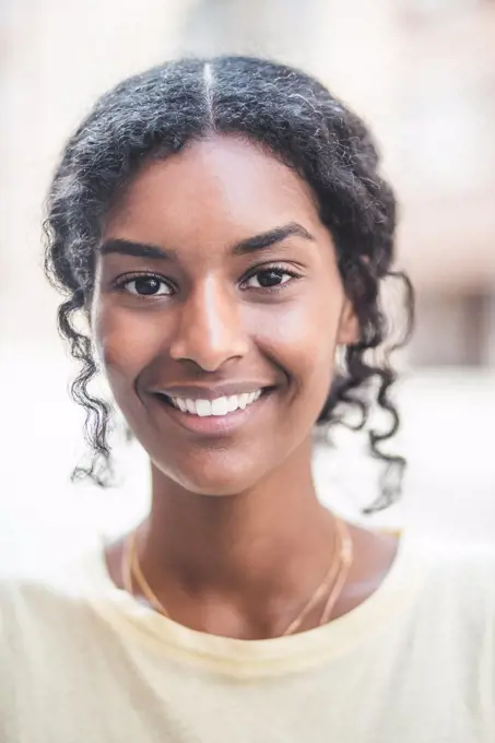 Portrait of smiling woman in city