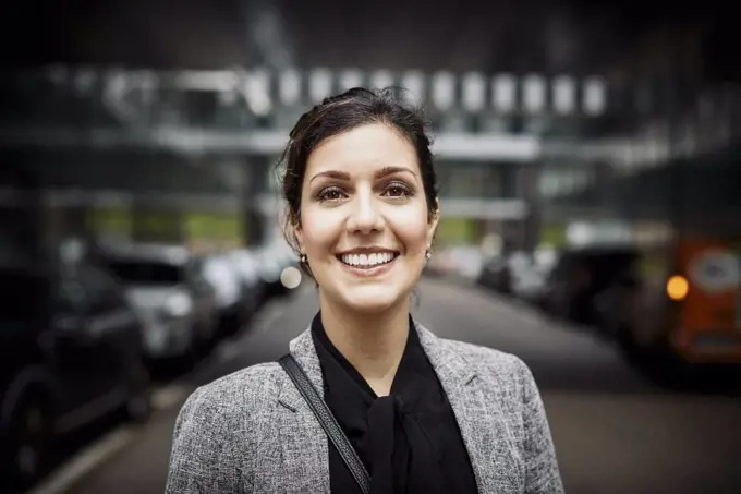 Portrait of smiling confident female lawyer in formals at workplace