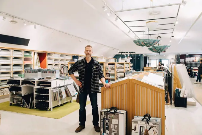 Full length portrait of man standing in store