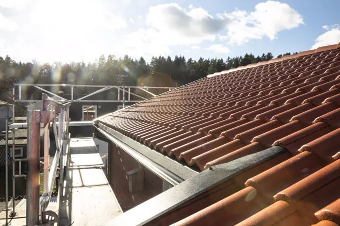 Rooftop against sky on sunny day