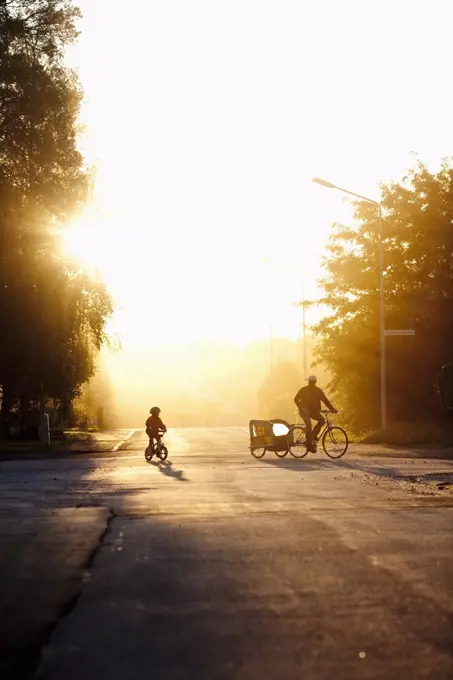 Two biking in sunshine