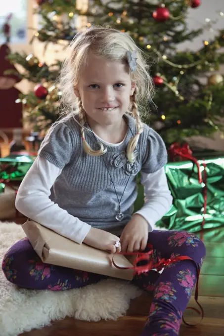 Girl opening christmas present