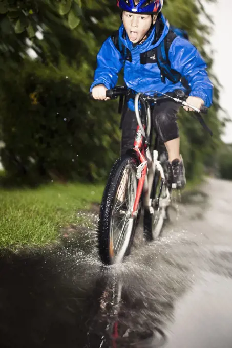 Full length of boy enjoying his cycle ride