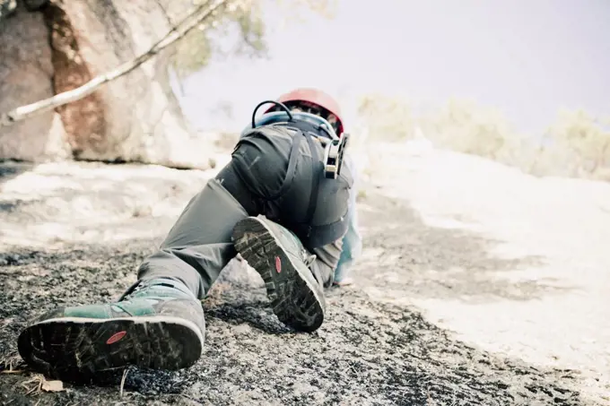 Low section of boy rock climbing