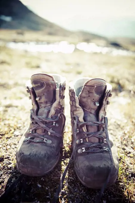 Pair of dirty hiking boots on land