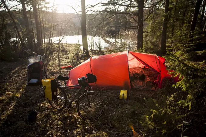 Tent and bicycle at lakeshore