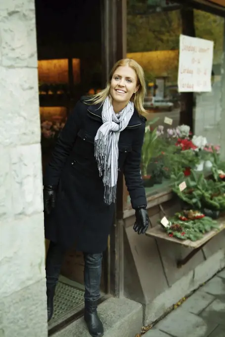 Woman looking out from a store