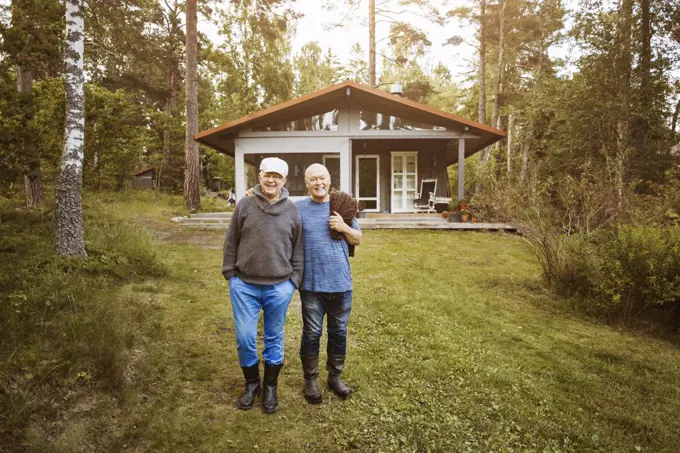 Portrait of happy gay couple standing at lawn