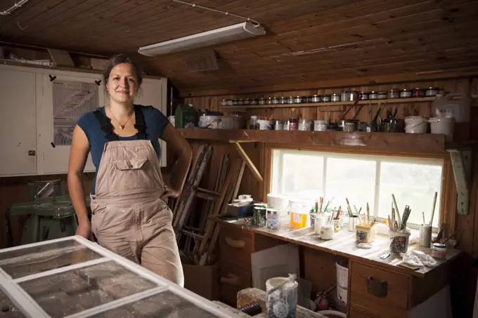 Portrait of confident upholsterer standing at workshop