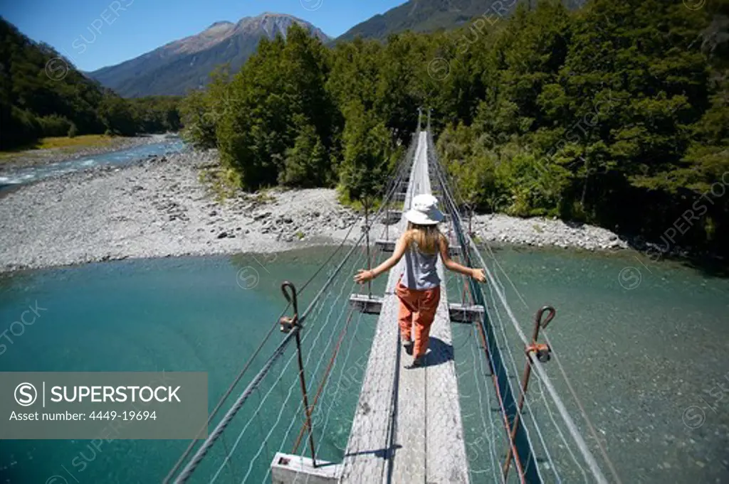 Girl on hanging bridge, track to Blue Pools, east of Haast Pass, Southern Alps, South Island, New Zealand