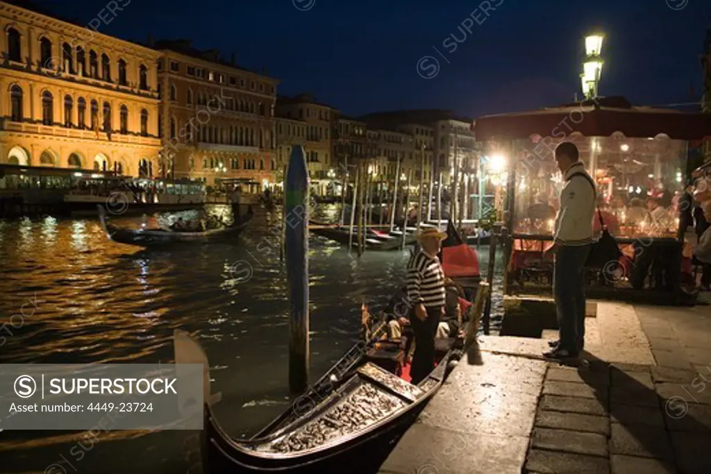 Gondoliers with Gondols on Grand Canal at night, Venice, Veneto, Italy