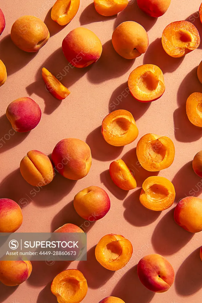 Scattered apricots, whole and halved