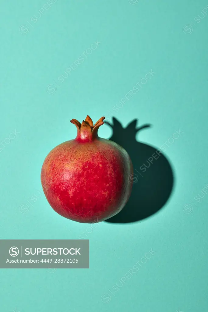 Pomegranate on turquoise background