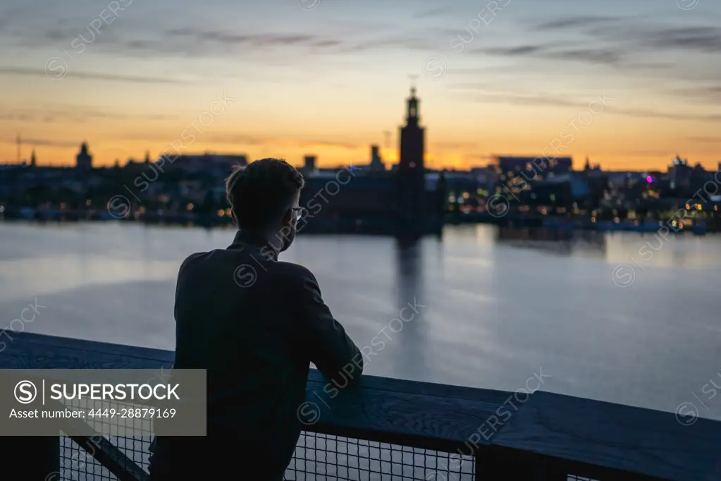 Tourist looking at the sunset over Stockholm, Sweden