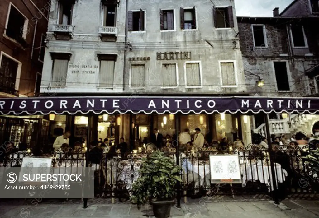 People sitting at outdoor seating of Restaurant Antico Martini, Venice, Italy