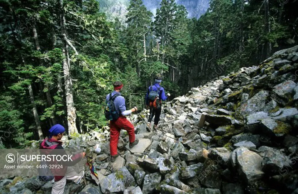 Three mountaineers decending from Mt. Shei at Shei-Pa National Park, Taiwan, Asia