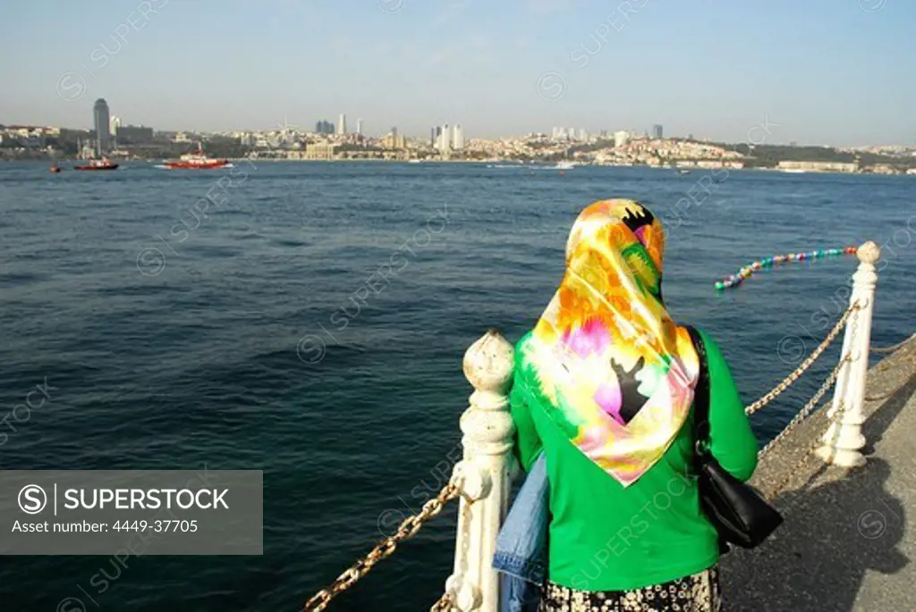 Woman with headscarf at the Bosphorus, Bogazici, in Ueskuedar, Uskudar, view of Besiktas, Istanbul, Turkey, Europe