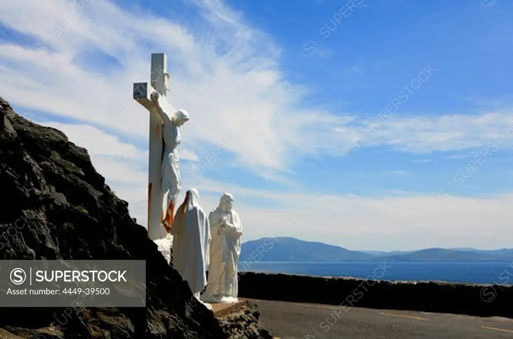 Statue of Christ in the sunlight above Dingle Bay, Slea Head, Dingle Peninsula, County Kerry, west coast, Ireland, Europe