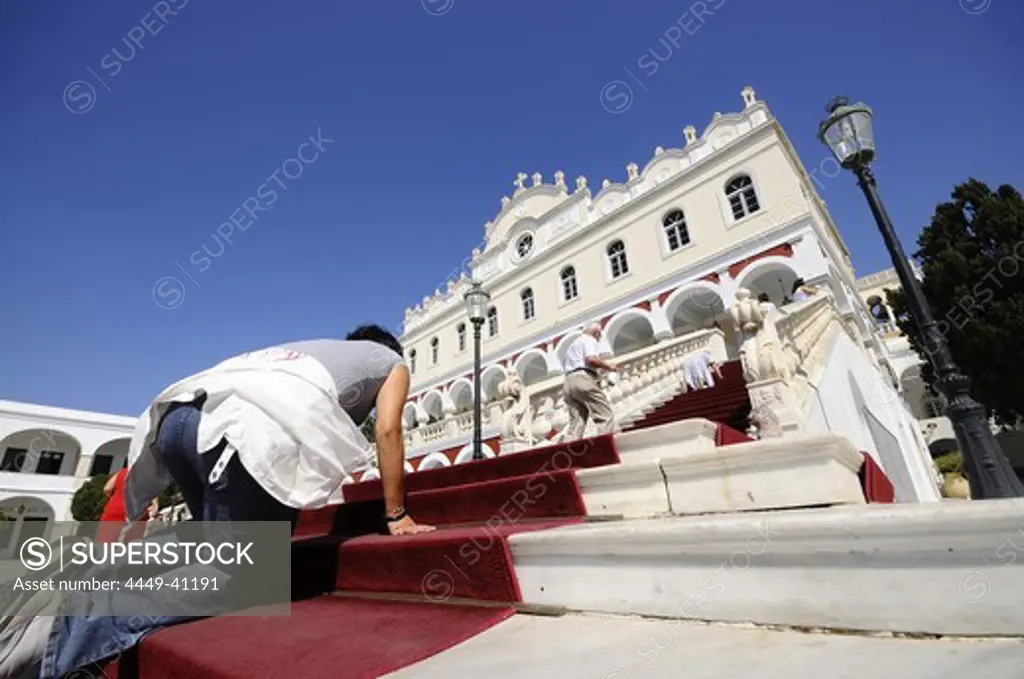 Pilgrim on the stairs of pilgrimage basilica Panagia Evangelistria, Tinos-town, island of Tinos, the Cyclades, Greece, Europe