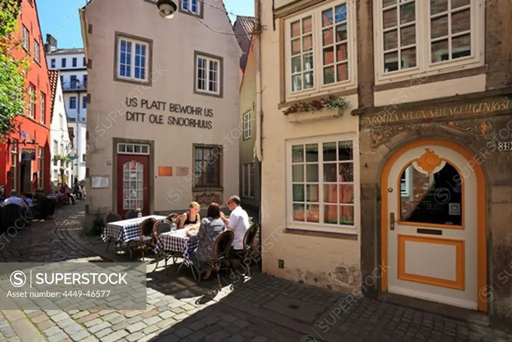 People at street cafe and historical houses at Schnoor quarter, Hanseatic City of Bremen, Germany, Europe