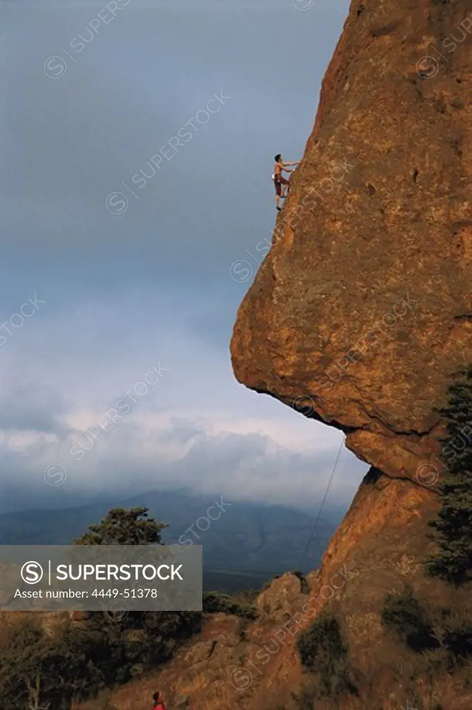 Climber on rock face formed as nose, Swinburne, South Africa