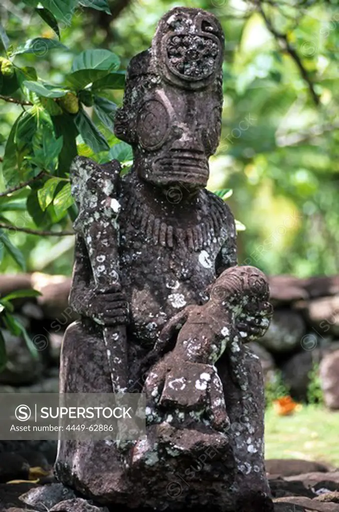 Weather beaten statue made of stone, Tiki in the village of Hatiheu on the island of Nuku Hiva, French Polynesia