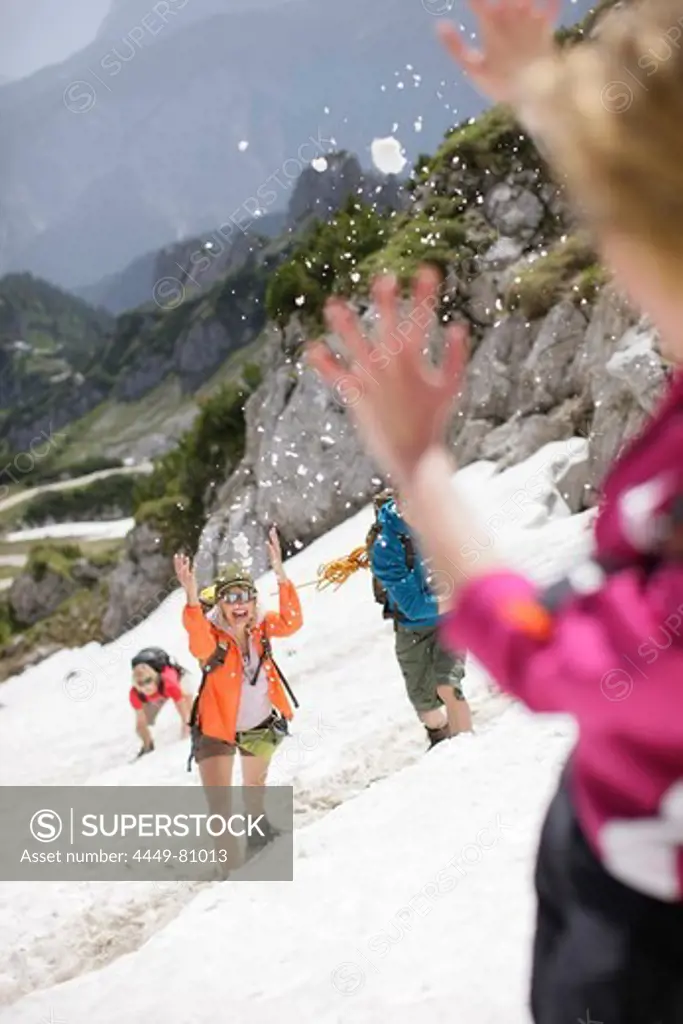 Young people snowball fighting, Werdenfelser Land, Bavaria, Germany