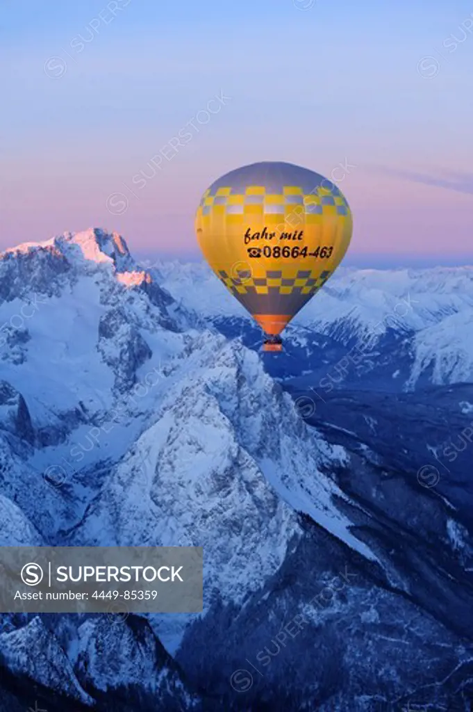 Hot-air balloon flying above Zugspitze and Waxensteine, aerial view, Garmisch-Partenkirchen, Wetterstein range, Bavarian alps, Upper Bavaria, Bavaria, Germany, Europe