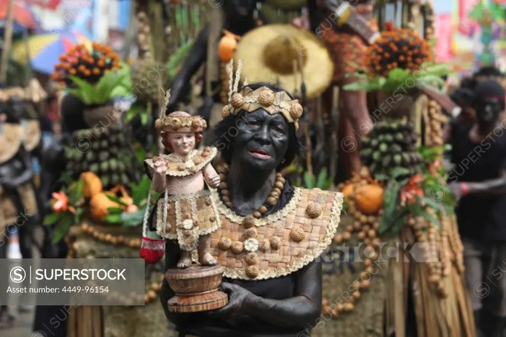 Old woman holding a Santo Nino figur, Ati Atihan Festival, Kalibo, Aklan, Western Visayas Region, Panay Island, Philippines