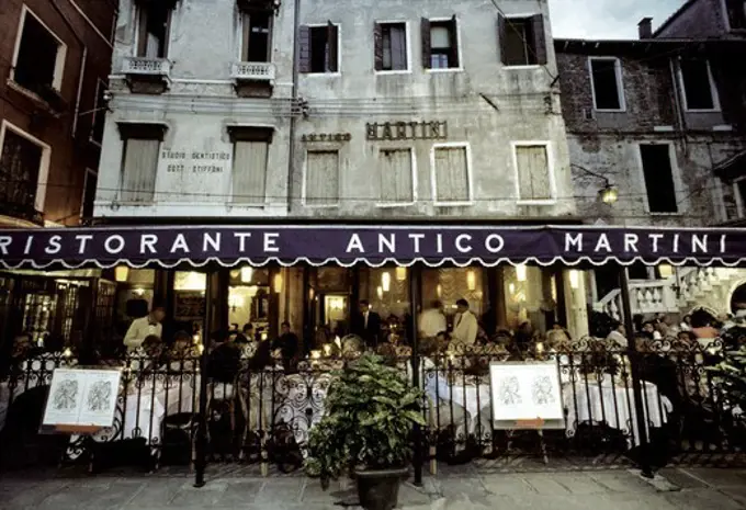 People sitting at outdoor seating of Restaurant Antico Martini, Venice, Italy