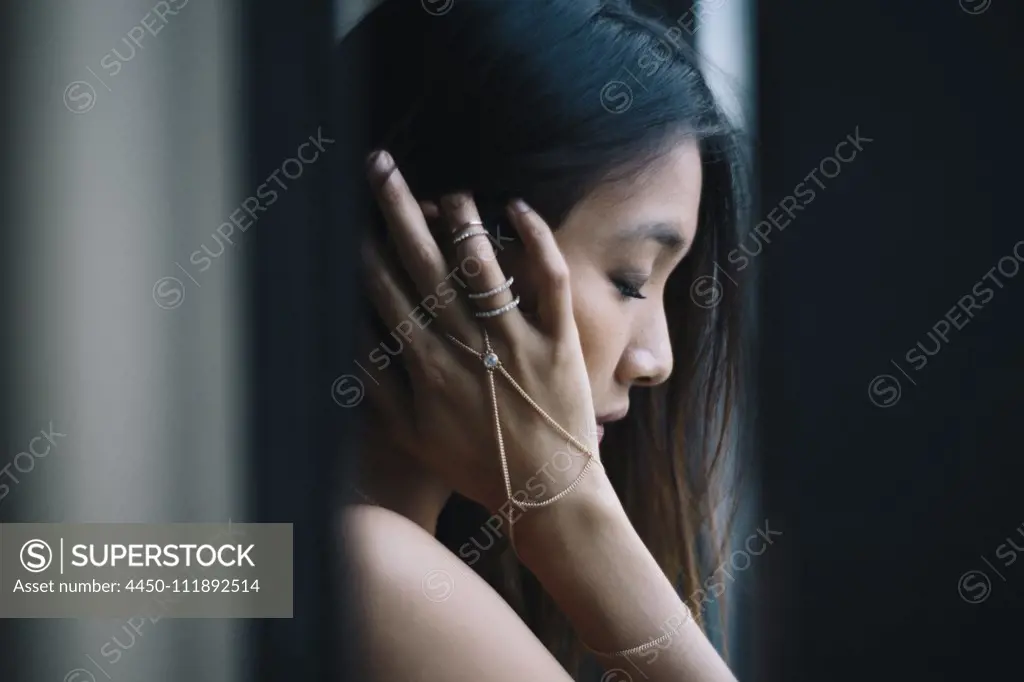 Portrait of young woman near a window in Singapore.