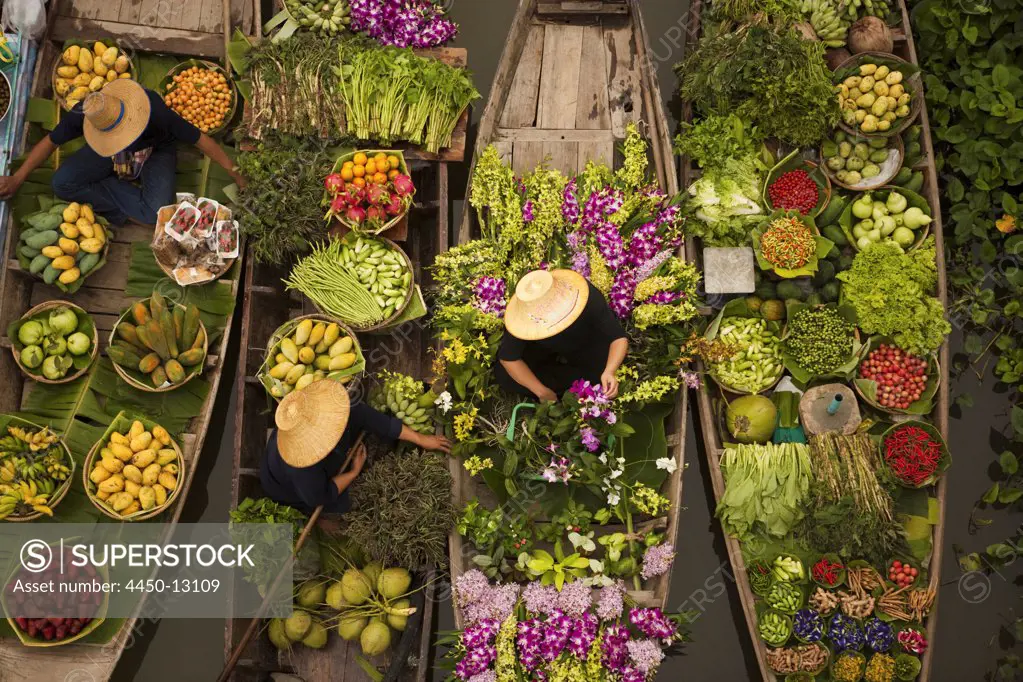 Aerial view of a floating market on a canal in Bangkok, local boats laden with fresh food, moored close together.  April 3, 2005