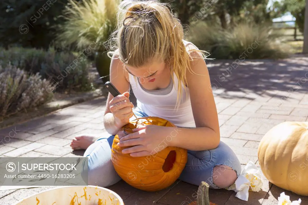 11 year old girl carving a pumpkin