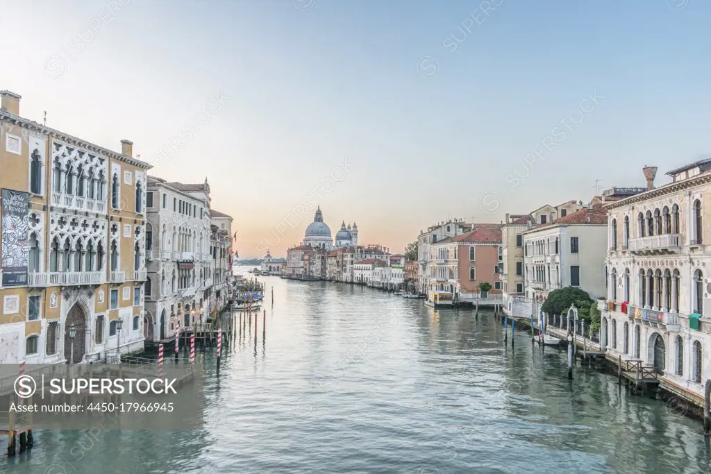 View of the Grand Canal in Venice with St Mark's Basilica dome in the distance.