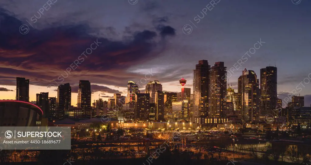 Calgary cityscape lit up at sunset.