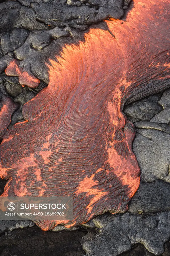 Lava flow over volcanic black rock.